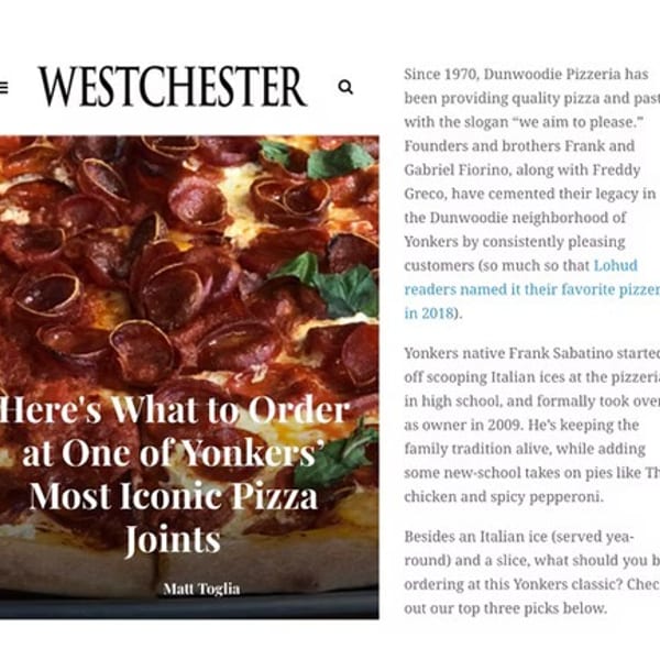 Close-up of a pepperoni pizza with basil leaves on a Westchester magazine article.