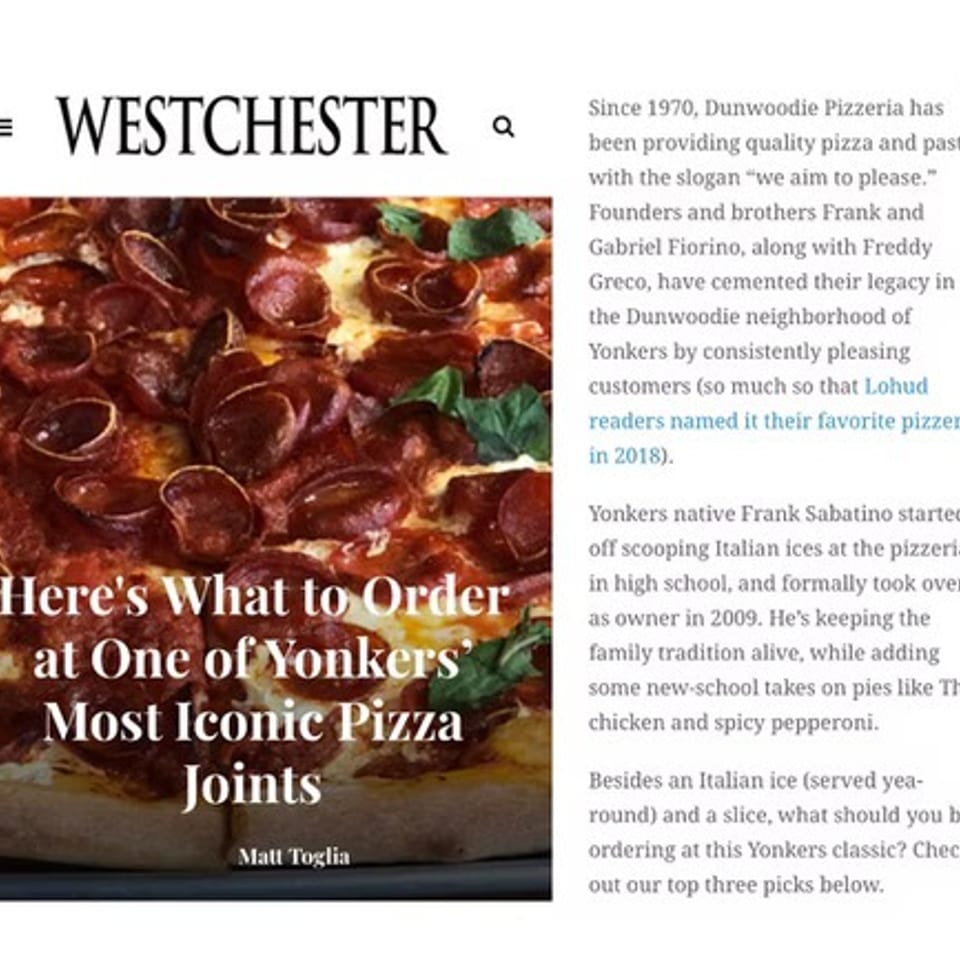 Close-up of a pepperoni pizza with basil leaves on a Westchester magazine article.