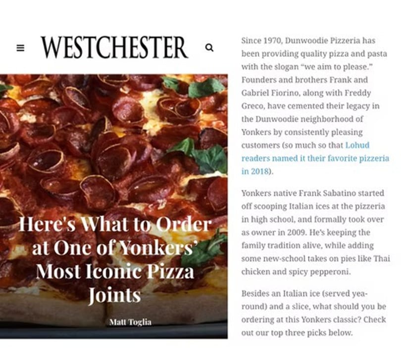 Close-up of a pepperoni pizza with basil leaves on a Westchester magazine article.